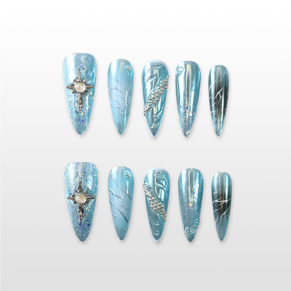 Handmade icy blue press on nails with pearl cross charm and silver glitter details
