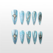 Handmade icy blue press on nails with pearl cross charm and silver glitter details