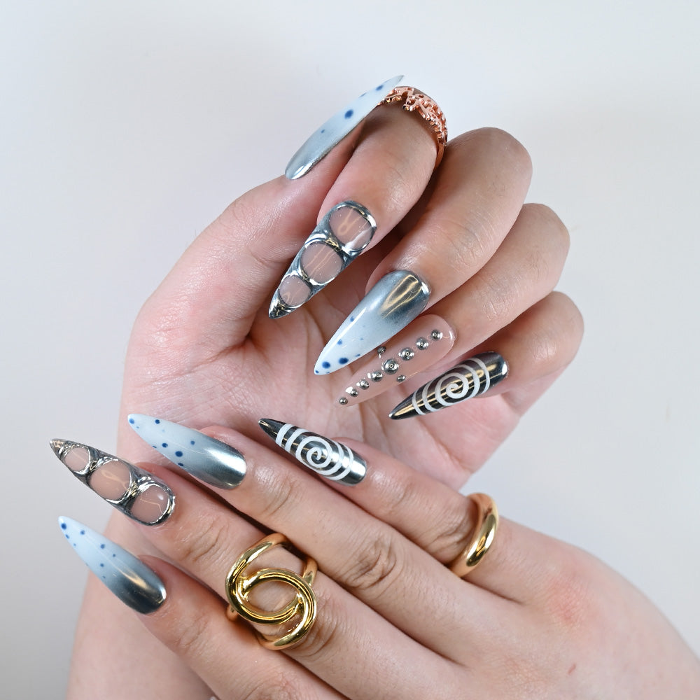 Futuristic ombre nails in silver and nude with chrome rings and dot patterns