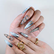 Futuristic ombre nails in silver and nude with chrome rings and dot patterns