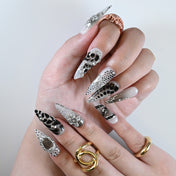 Monochrome gradient nails with 3D crystal designs and polka dot patterns