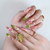 Handmade pink glitter and green ombré nails featuring large 3D flowers