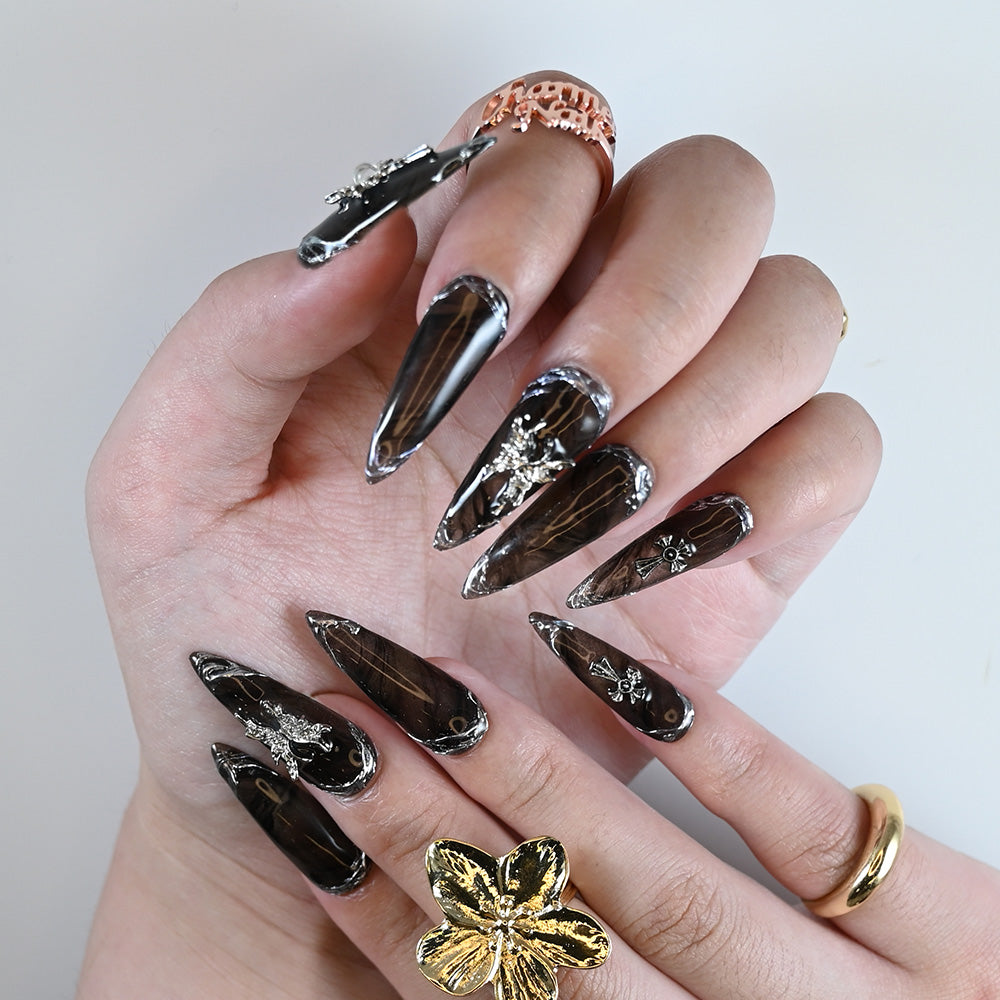 Luxury black marble effect nails featuring 3D silver embellishments