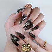 Luxury black marble effect nails featuring 3D silver embellishments