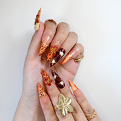 Luxury wild style nails with 3D floral art, gold accents, and gradient tips