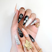 Handmade mixed black, nude, and silver nails with marble lines and gemstone accents