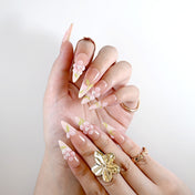 Handmade nude pink nails with delicate 3D floral art and leaf details