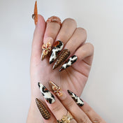 Handmade acrylic nails featuring leopard texture, tortoiseshell pattern, and orange tones