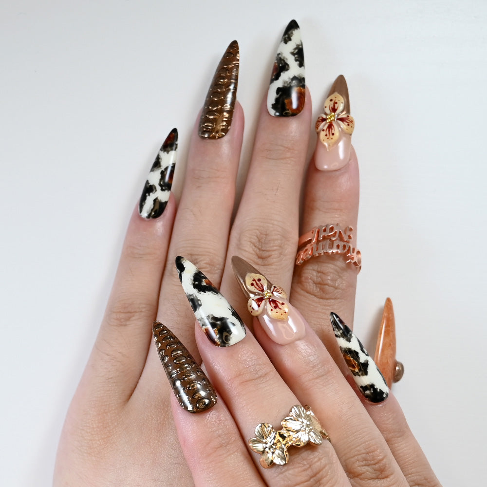 Reusable press-on nails with bold animal print and artistic flower details