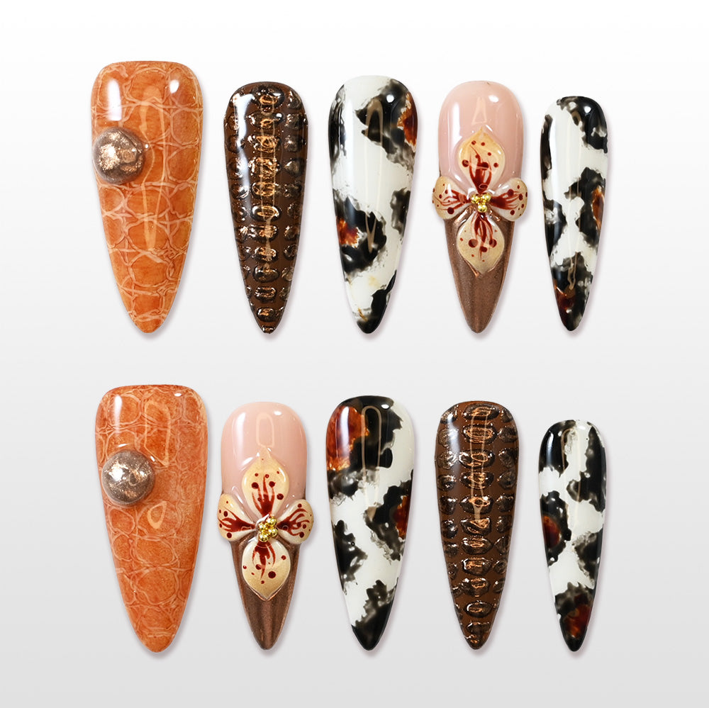 Long press-on nails with animal print, metallic bronze, and 3D floral accent