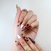 Reusable burgundy press-on nails with gold star and floral art