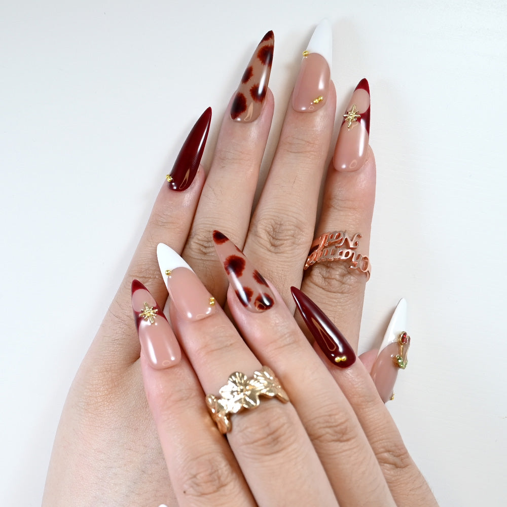 Fall party nails with cherry gem, wine red petals, and glossy finish