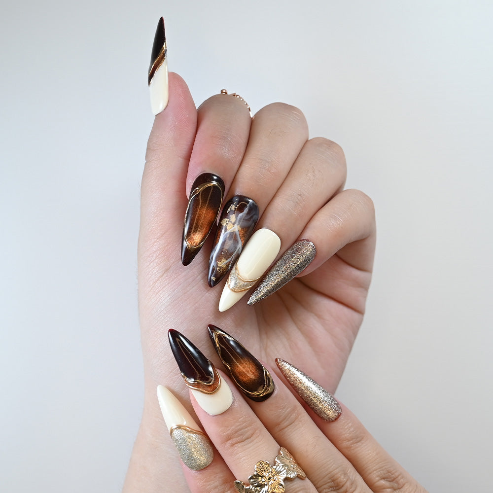 Reusable press-on nails with elegant black, white, and metallic gold accents