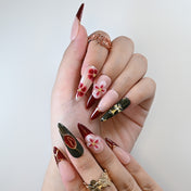Luxury salon-quality press-on nails in deep red and black with elegant floral accents