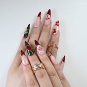 Reusable press-on nails featuring burgundy gradient, golden cross charm, and 3D design
