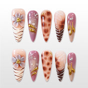 Handmade nude nails with animal print design and luxury gold details