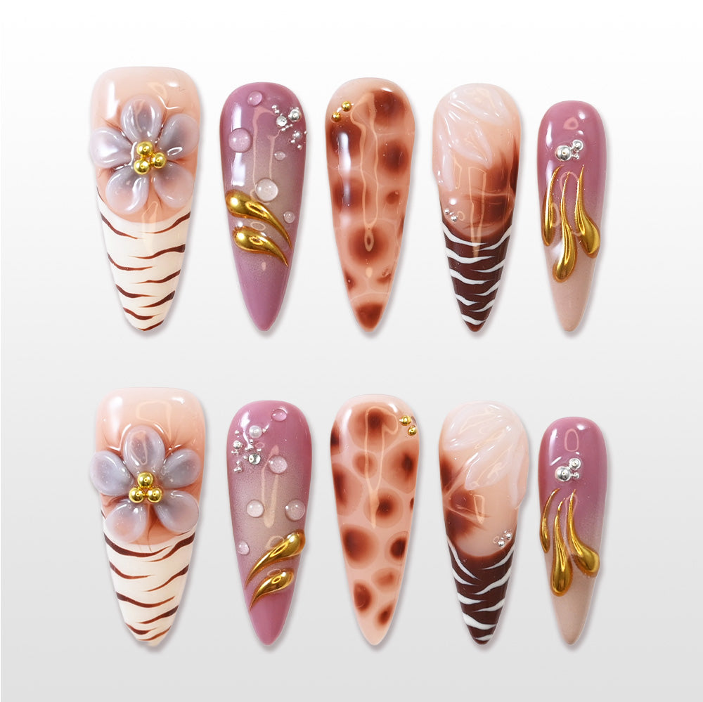 Handmade nude nails with animal print design and luxury gold details