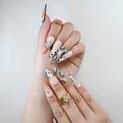 Reusable press-on nails with black and brown cow print, crystal rhinestone accents