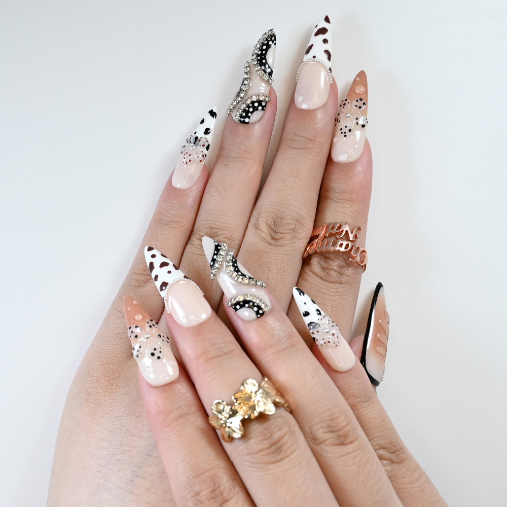 Luxury press-on nails in nude and white with 3D flowers, leopard details and glam rhinestones