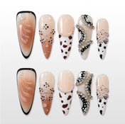 Handmade acrylic nails featuring nude gradient, animal print and sparkling gems