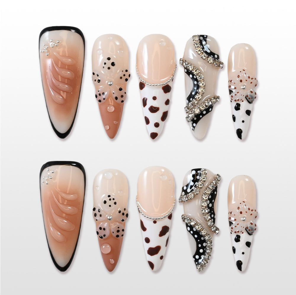 Handmade acrylic nails featuring nude gradient, animal print and sparkling gems