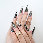Reusable stiletto nails with gold shimmer and black lace details