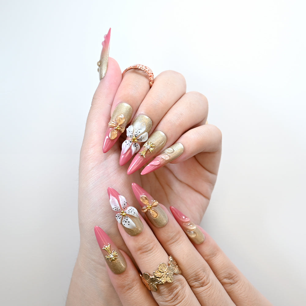 Handmade luxury nails with gold shimmer and metallic floral accents