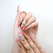 Handmade luxury nails with gold shimmer and metallic floral accents