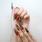 Reusable press-on nails with glitter gold base and cherry fruit charm