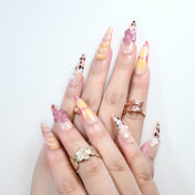 Trendy press-on nails with leopard tips, rhinestones, and 3D petals