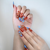 Charmeenail luxury acrylic nails in red marble with bold blue and flower details