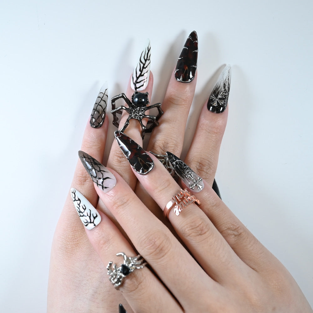 Charmeenail acrylic nails featuring creepy black and silver pumpkin face details