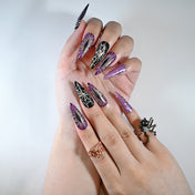 Charmeenail acrylic nails featuring spooky spider details and metallic purple shine