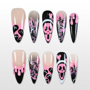 Handmade pink and black press on nails with ghost faces, scream mask and spooky flower art