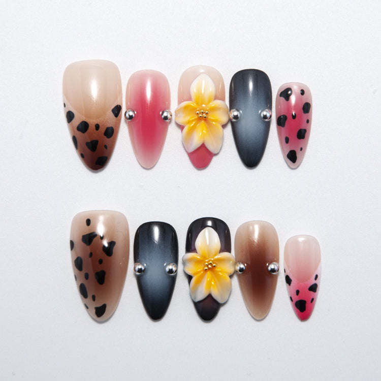 Handmade gradient nails with animal print, 3D plumeria flower, and metallic bead charms