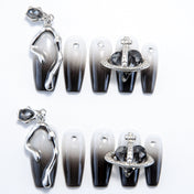 Handmade gradient nails with metallic 3D accents and dangling gemstone charm