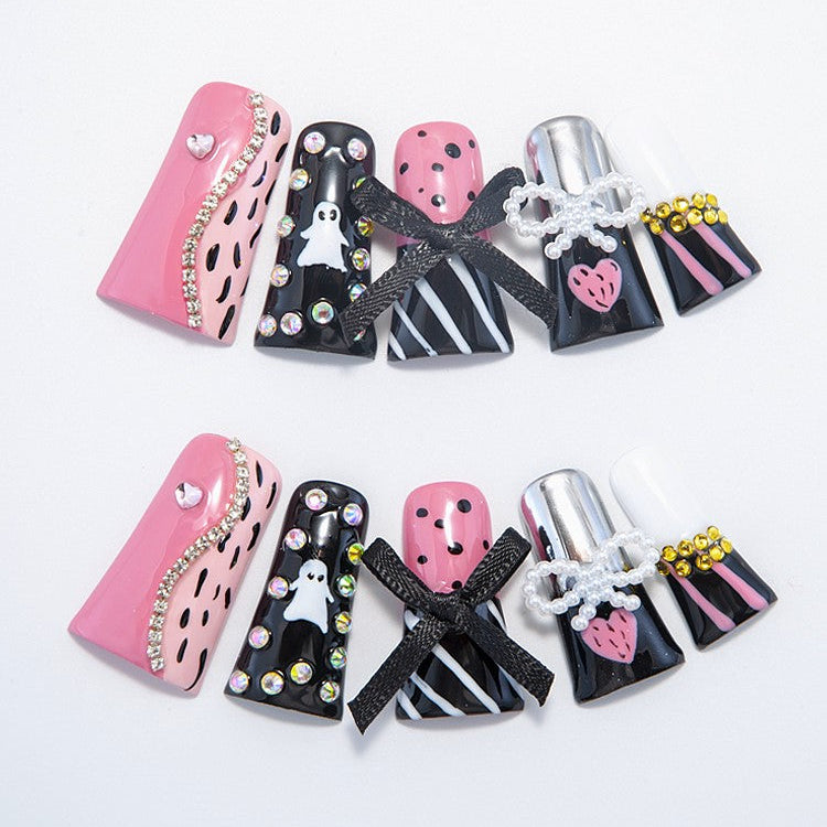 Handmade Halloween nails with ghost designs, black stripes, and crystal accents