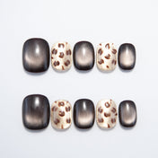 Square toe press-on nails with gold leopard print and black cat eye gradient