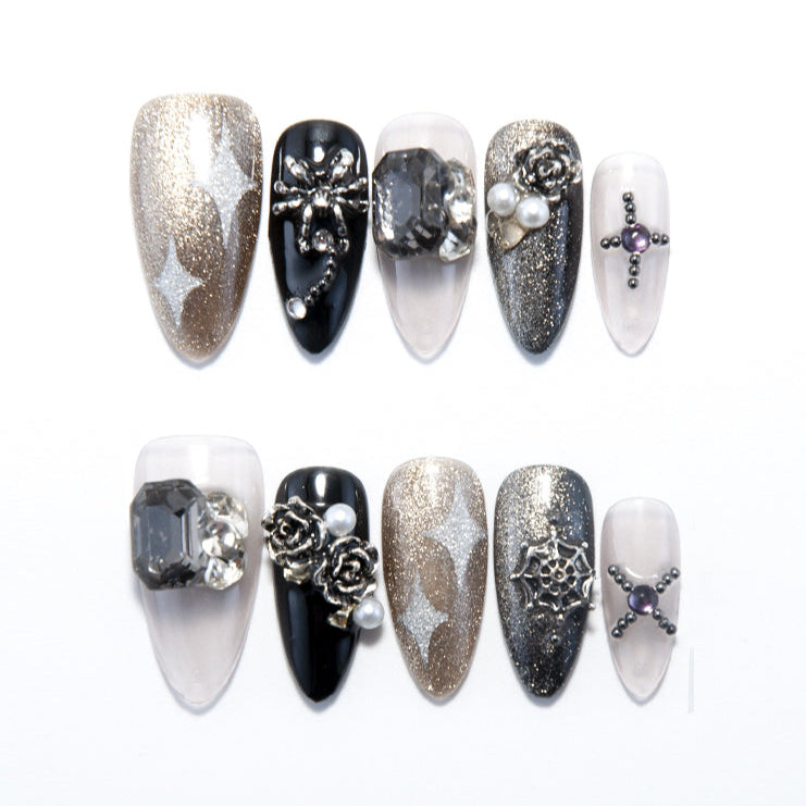 Black and gold press-on nails with silver glitter stars and 3D rose accents