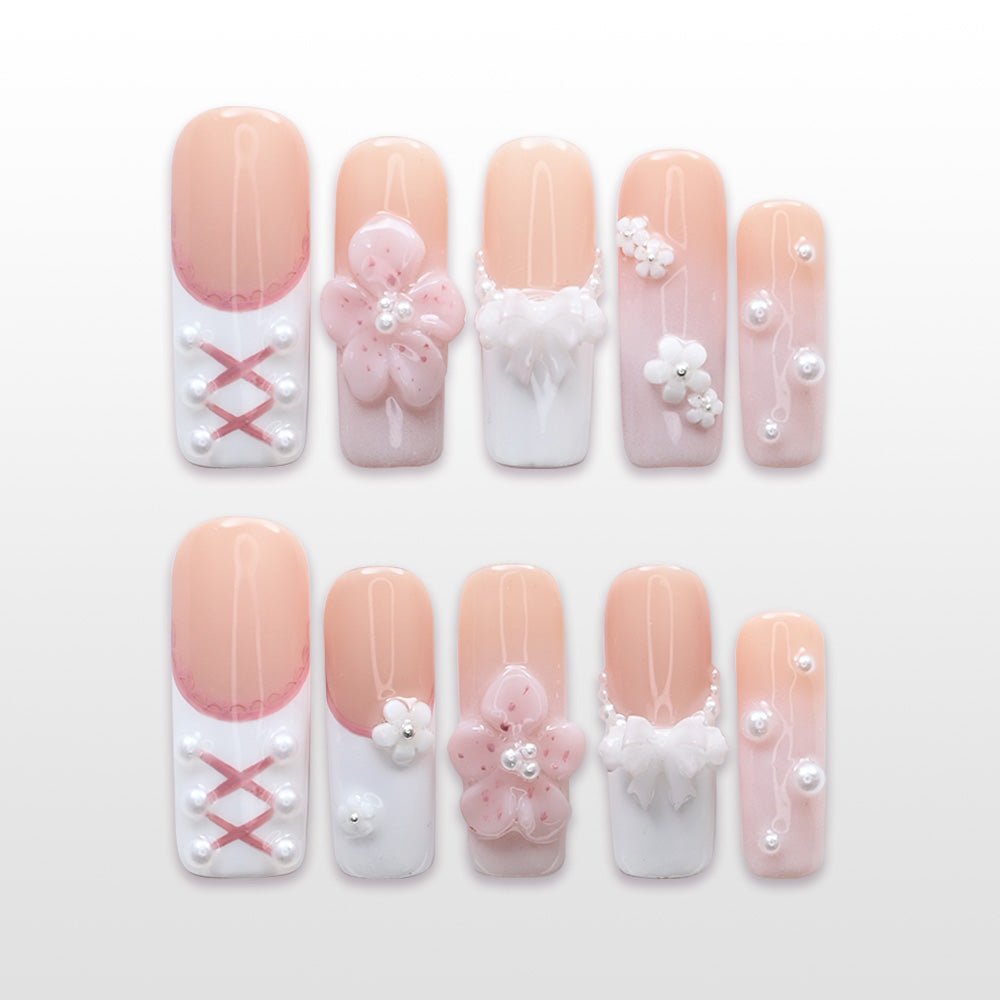 Pink and white lace corset press-on nails with pearls and 3D floral accents