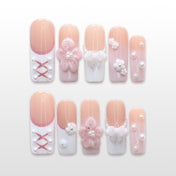 Pink and white lace corset press-on nails with pearls and 3D floral accents