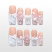 Elegant bridal press-on nails with white French tips, 3D flowers, and pearl accents