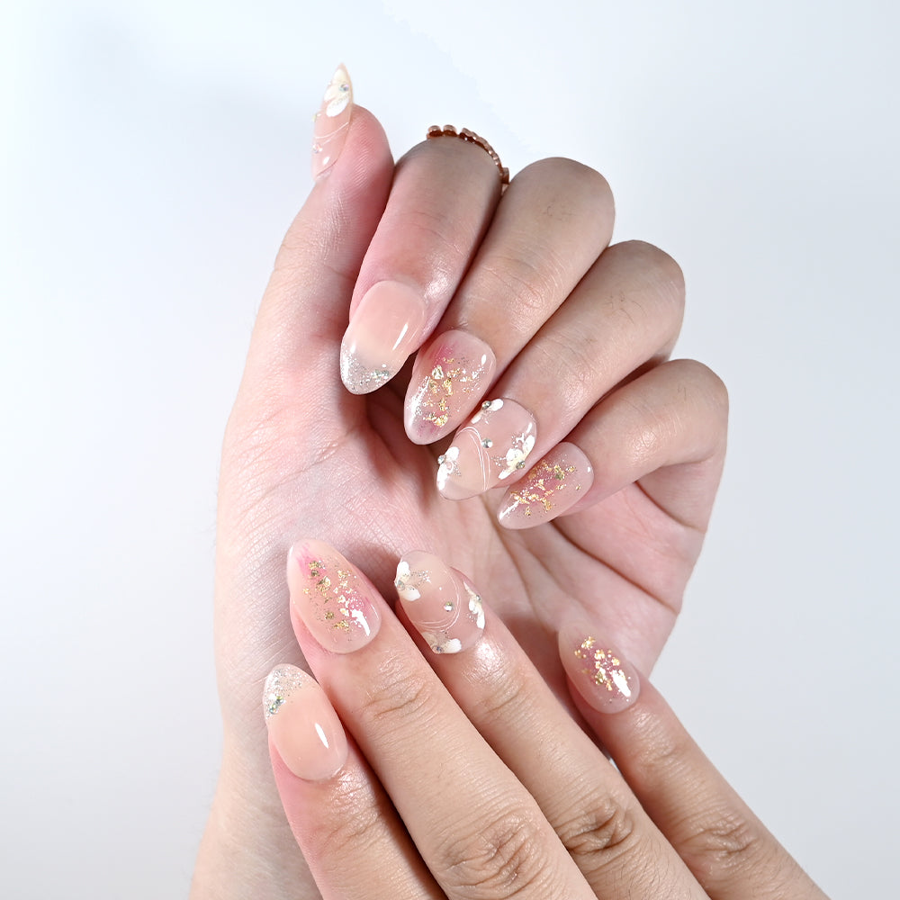 Handmade short almond nails with glitter, rhinestones, and floral details