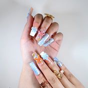 Charmeenail acrylic nails featuring pastel blue, coral starfish, and beach style nail art