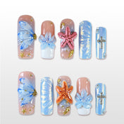 Handmade blue and nude press on nails with 3D flowers, starfish, and ocean theme design