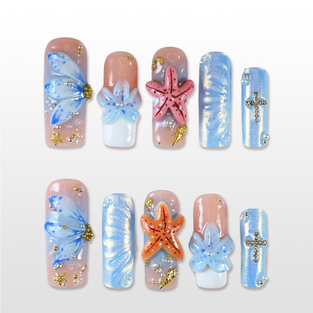 Handmade blue and nude press on nails with 3D flowers, starfish, and ocean theme design