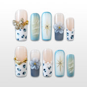 Blue and white leopard print press-on nails with rhinestone butterfly and 3D flowers