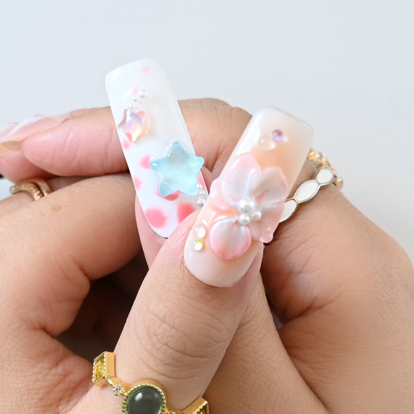 Luxury multicolor nail art with green, blue, yellow tips and 3D embellishments