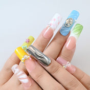 Handmade rainbow nails with 3D floral designs, rhinestones, and metallic silver