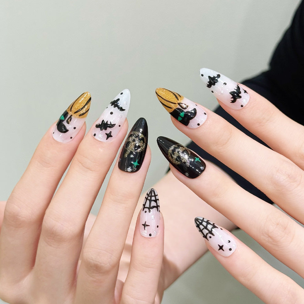 Medium Almond acrylic nails featuring glitter pumpkins, flying bats and spooky web details